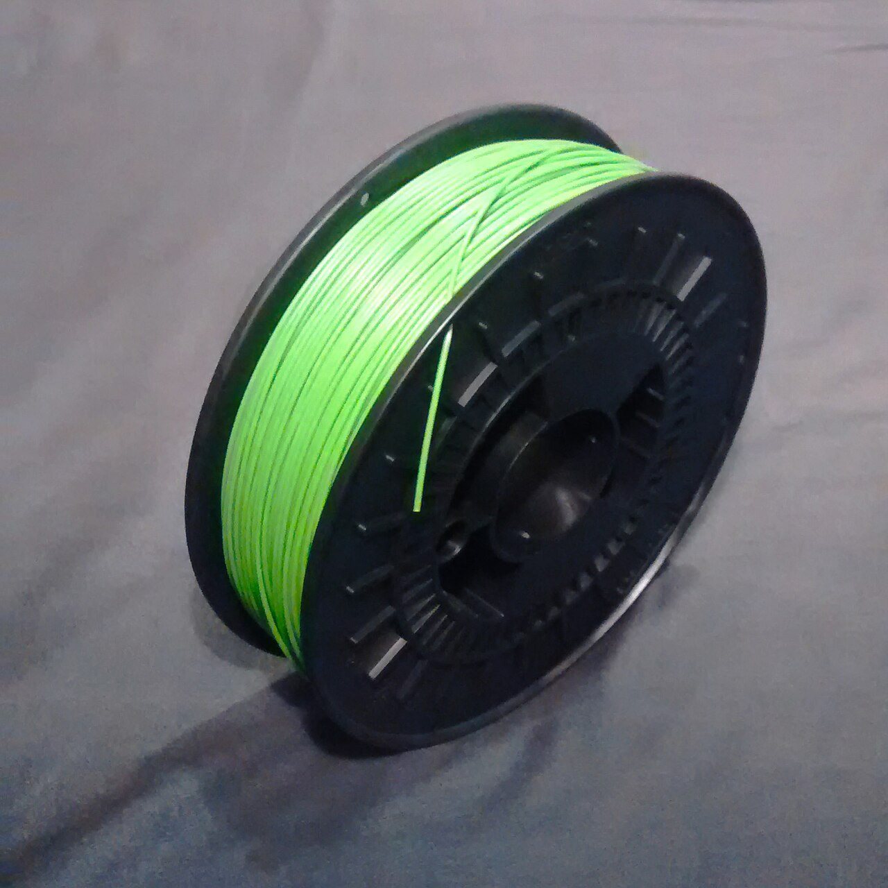 A one kilogram reel of unused PLA filament