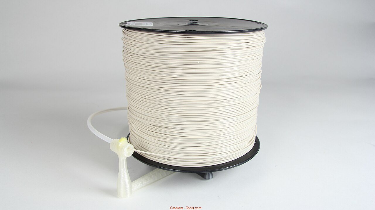 A part-used spool of filament sitting on a digital kitchen scale
